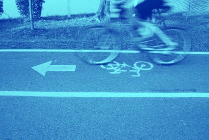 A person riding their bike on the street.