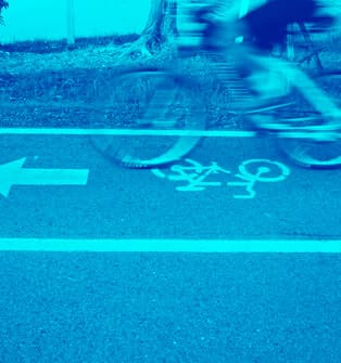 A person riding their bike on the street.