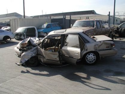 A car that has been smashed in to pieces.