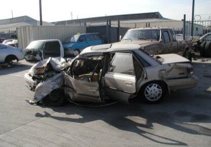 A car that has been smashed in to pieces.